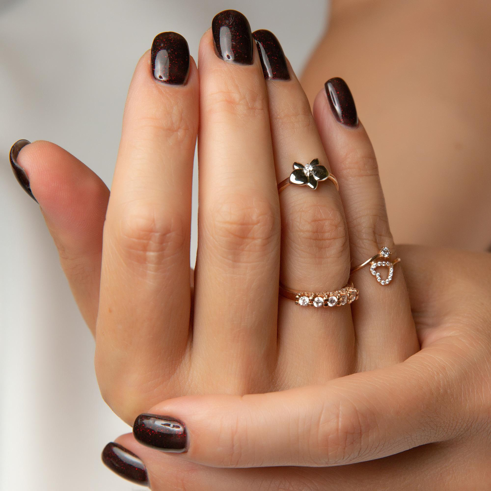 woman-s-hand-with-ring-it-nails-are-painted-maroon